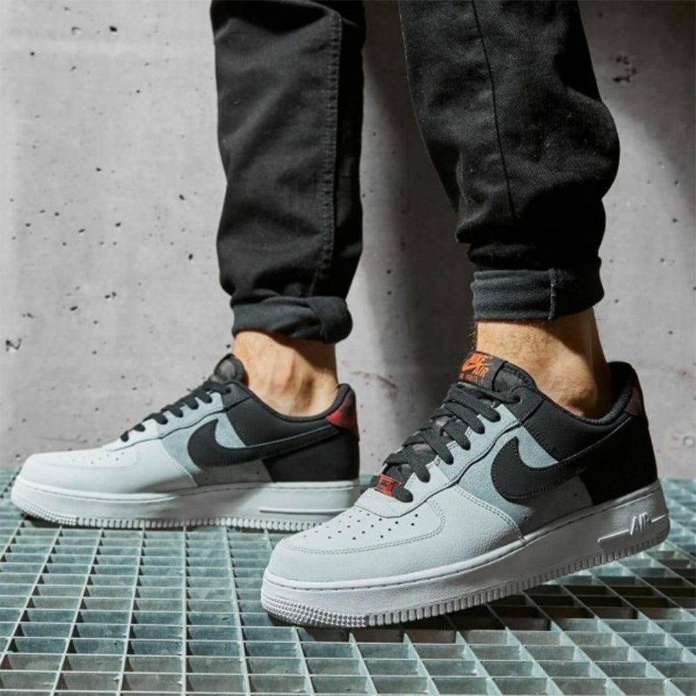 Air Force 1 Low '07 Black Smoke Grey' sneakers worn on feet, showcasing their stylish design and comfortable fit for everyday wear.