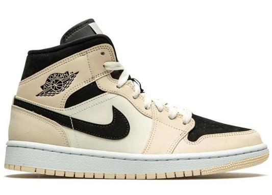 Jordan 1 Mid 'Guava Ice' sneaker featuring a beige and black colorway with a premium leather upper, black Nike Swoosh, and iconic Air Jordan Wings logo.