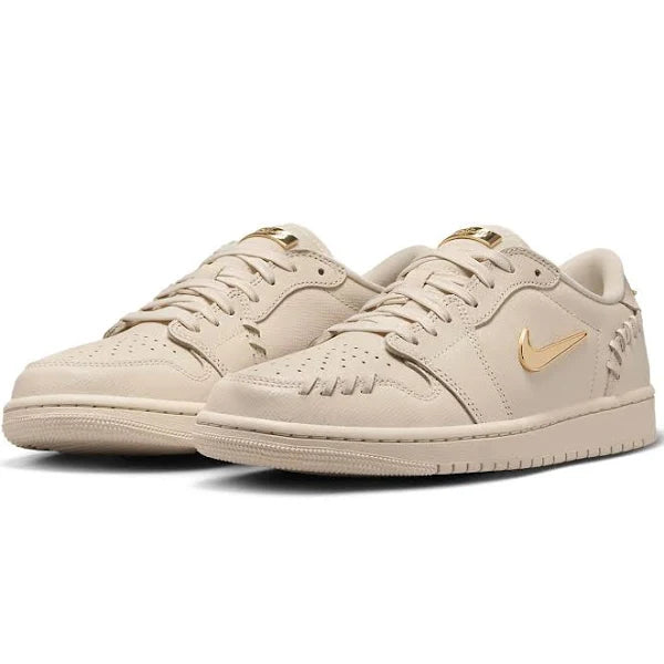 Side-angle view of the Jordan 1 Low - Method of Make 'Legend Light Brown' highlighting its elegant beige leather, gold accents, and unique stitching.