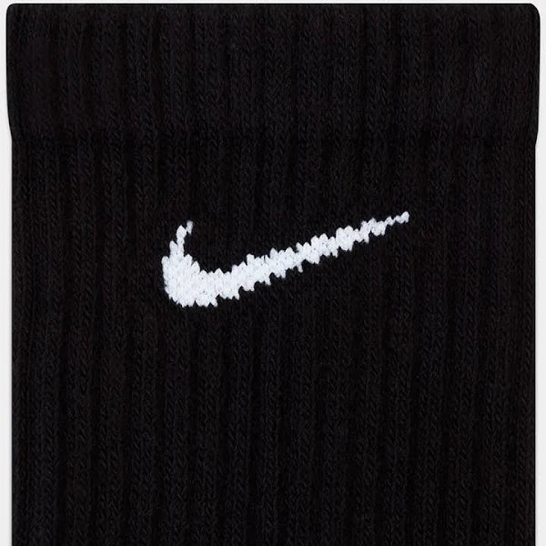 Detailed view of Nike Everyday Socks in black with a white swoosh logo. Ribbed texture enhances fit and comfort.