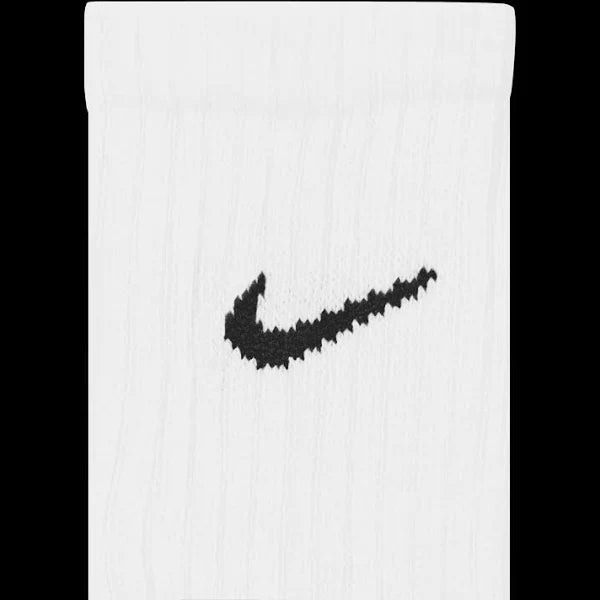 Close-up of Nike Everyday Socks in white, showcasing the embroidered black swoosh logo on ribbed fabric for a stylish look.