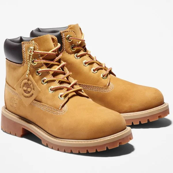 Pair of Timberland Premium 6-Inch Boots Unisex in wheat color, featuring waterproof nubuck leather and sturdy lace-up design.