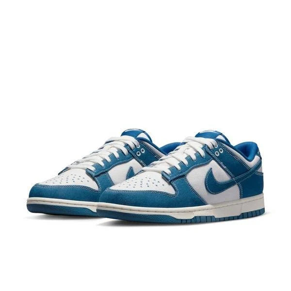 Pair of Nike Dunk Low ‘Industrial Blue’ sneakers showcasing blue denim and white leather upper with signature Swoosh branding and durable rubber sole.