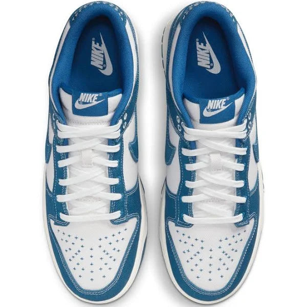 Top-down view of Nike Dunk Low ‘Industrial Blue’ sneakers, showcasing white laces, blue Nike branding on tongue, and perforated toe box for breathability.