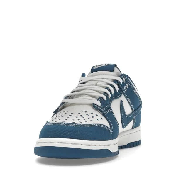 Front view of Nike Dunk Low ‘Industrial Blue’ sneaker, displaying white laces, perforated toe box, and blue denim paneling for a stylish finish.
