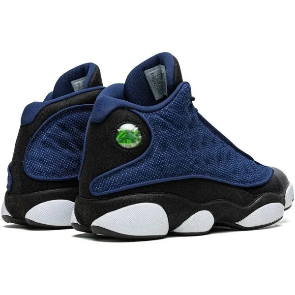 Rear view of the Air Jordan 13 'Brave Blur' highlighting the iconic holographic logo, padded collar, and premium suede detailing for a stylish finish.