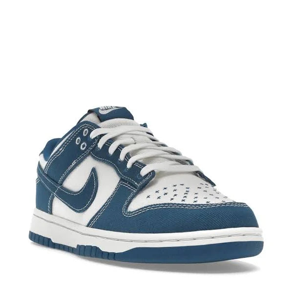 Nike Dunk Low ‘Industrial Blue’ sneaker in a side-front view, highlighting contrast stitching, perforated toe box, and premium denim-textured overlays.