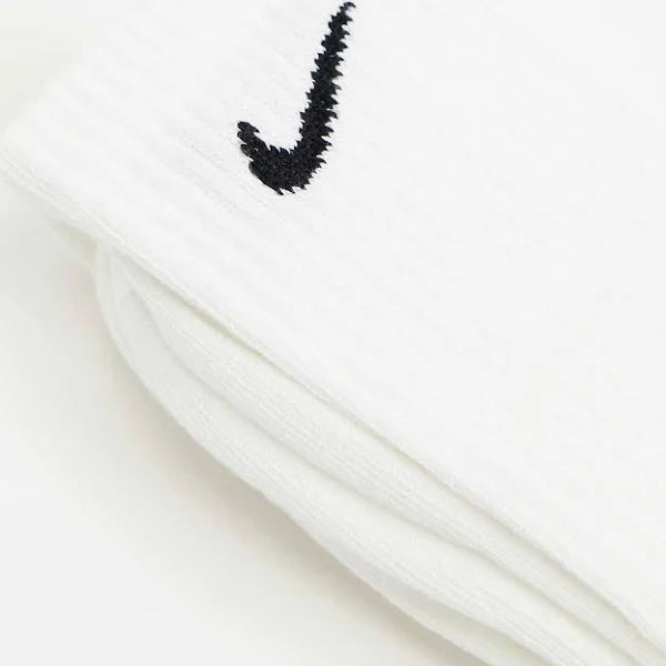 Folded Nike Everyday Socks in white with black swoosh logo. Soft, breathable fabric ensures all-day comfort and durability.