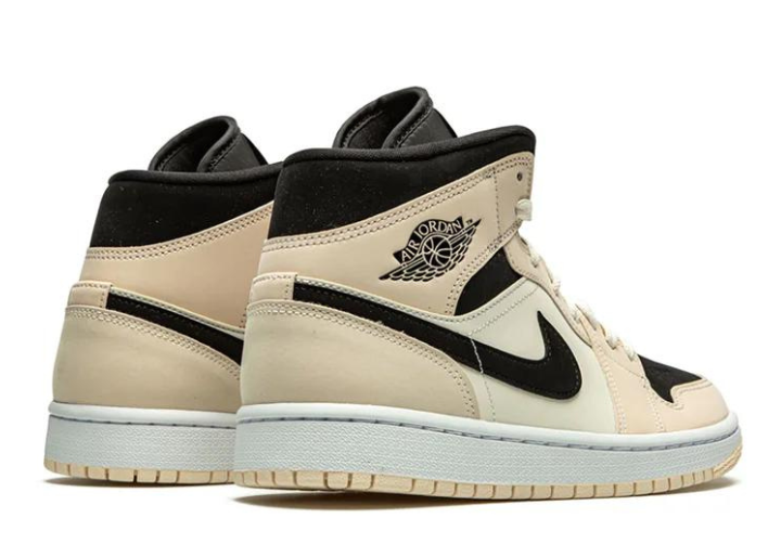 Rear view of the Jordan 1 Mid 'Guava Ice' showcasing the black collar, beige leather panels, and embossed Air Jordan Wings logo for a stylish finish.