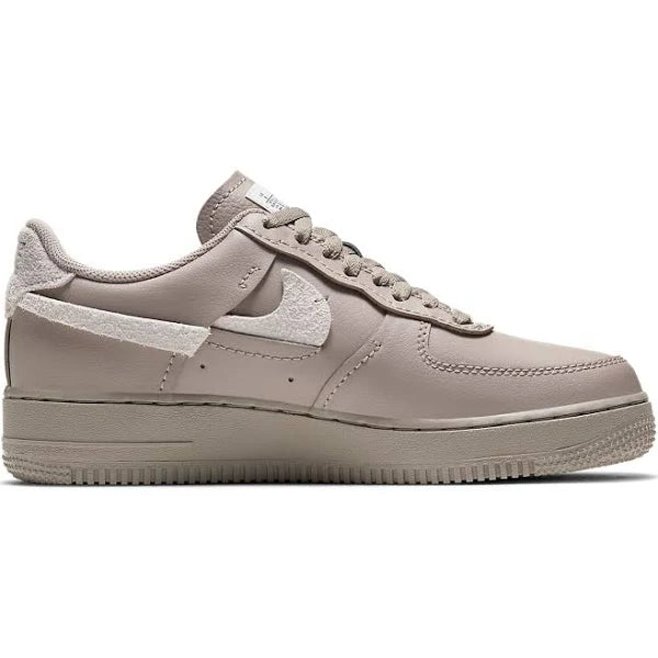 Nike Air Force 1 Low LXX 'Malt' sneaker in premium beige leather with deconstructed suede Swoosh and stitched details. Classic AF1 sole for comfort.