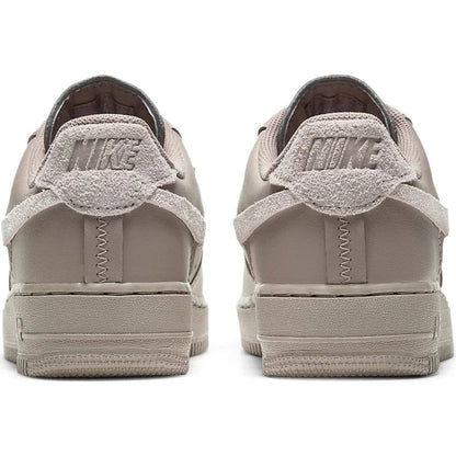 Rear view of Nike Air Force 1 Low LXX 'Malt' highlighting suede heel tab with embossed Nike branding and unique stitched detailing.