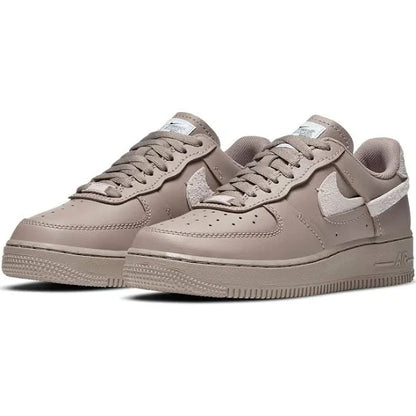 Pair of Nike Air Force 1 Low LXX 'Malt' sneakers featuring a refined beige leather upper, suede accents, and signature Air cushioning for all-day wear.